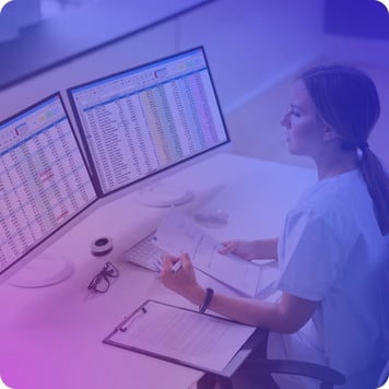 Healthcare professional analyzing monitoring data to prepare for a compliance audit.
